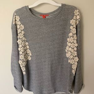 Gray sweater with floral patterning
